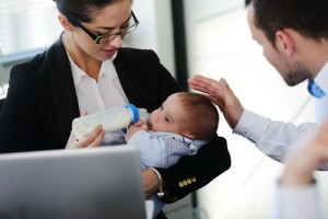 Business woman holding baby.