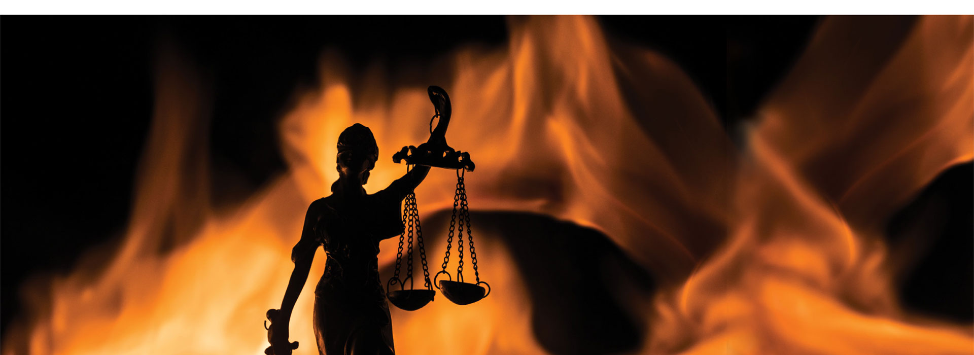 Lady Justice holding scales with a background that's on fire