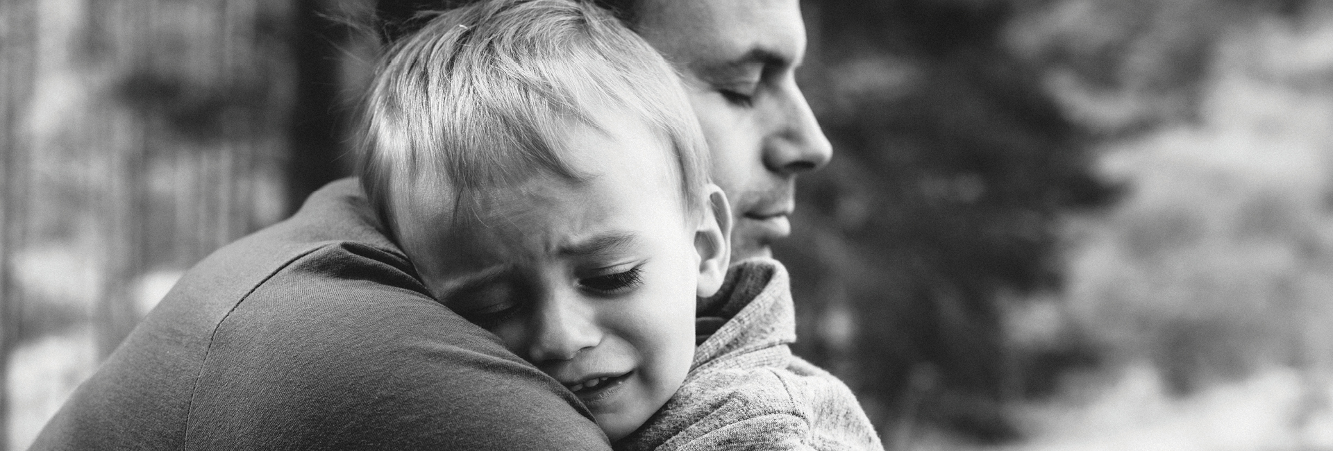 A father hugs a young child