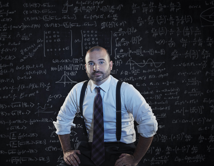 man in front of chalkboard