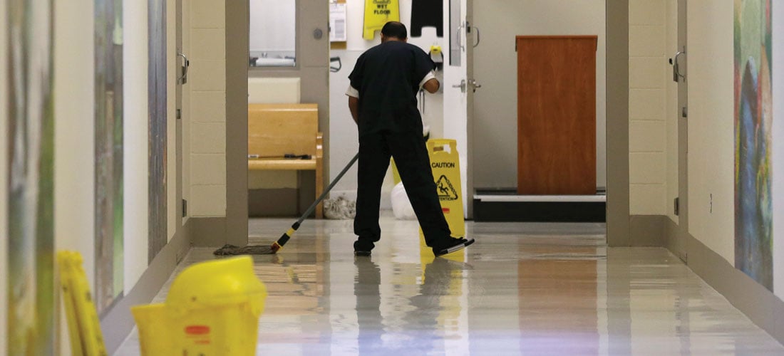 A detainee mops the floor in the Northwest Detention Center in Tacoma, Washington. 