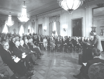 Men sitting in White House with President Kennedy