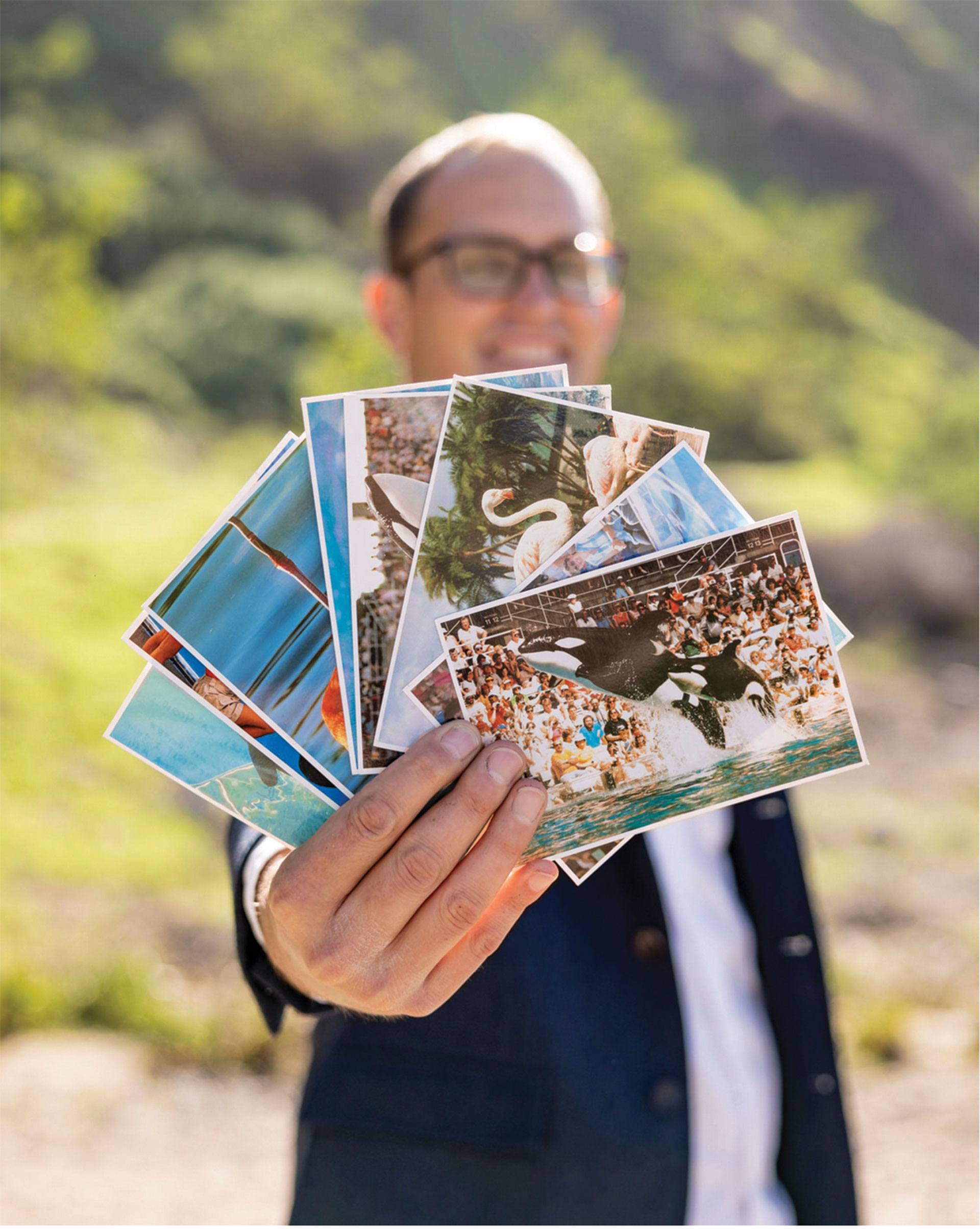 Matthew Strugar holding Sea World postcards