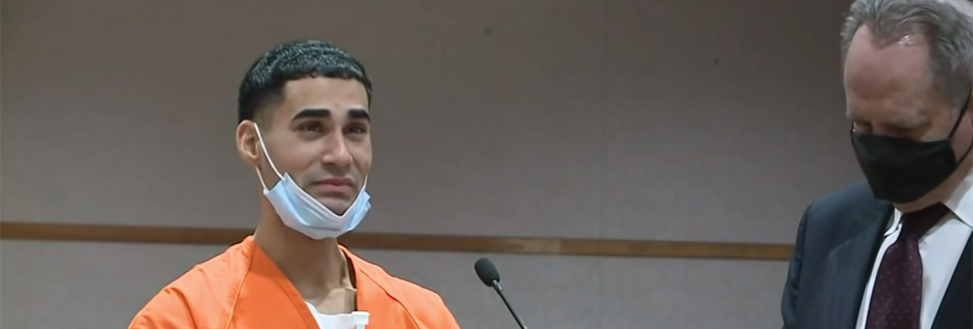 Rogel Aguilera-Mederos in a prison jumpsuit in court, crying.