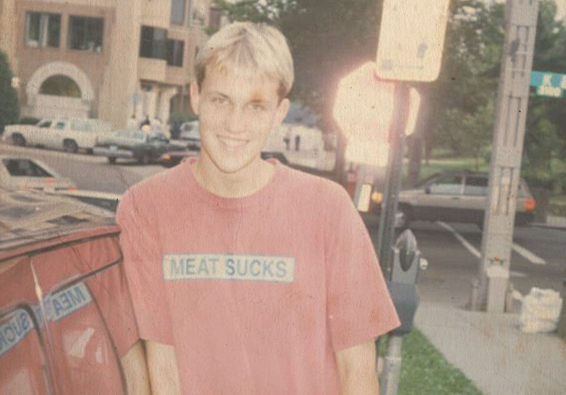 Teenage Matthew wearing a t-shirt that says Meat Sucks