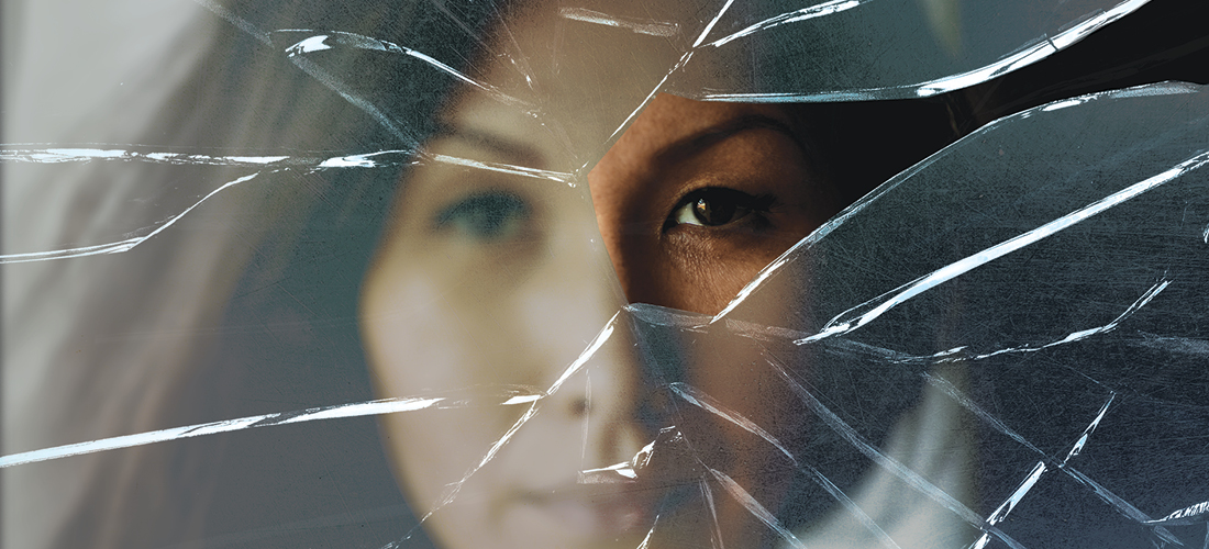 Woman behind a piece of shattered glass