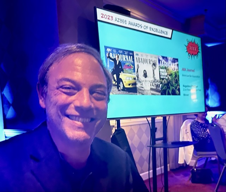 Kevin Davis smiling in front of a slide presentation