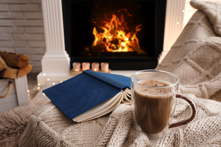 Cozy chair and cup of cocoa in front of a fire