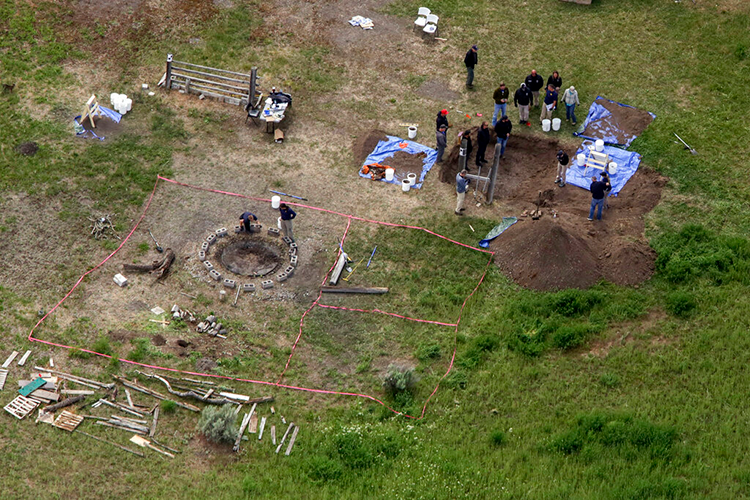 An aerial photo of police conducting a search and digging in the ground