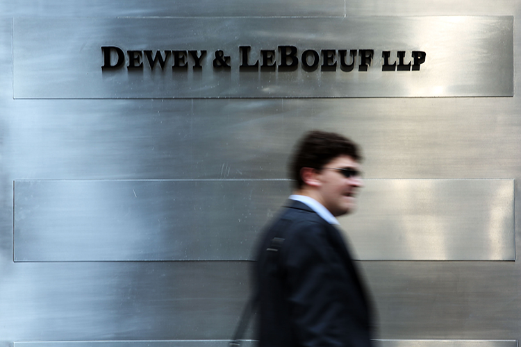 Blurry man walks past the Dewey & LeBoeuf headquarters sign