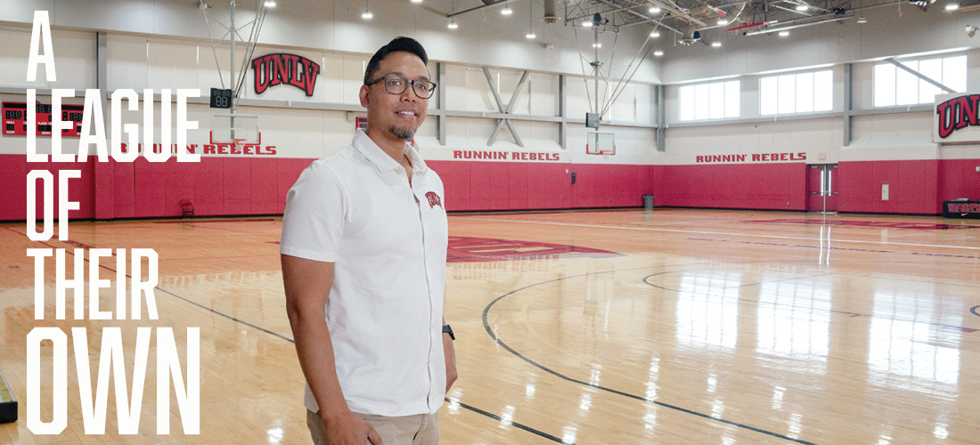 Eric Nepomuceno holding a basketball in gymasium.