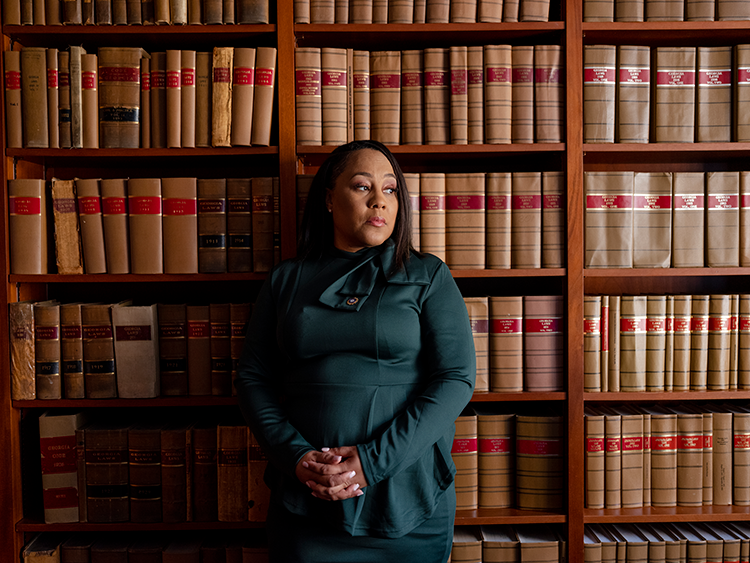 Fani Willis stands in a law library
