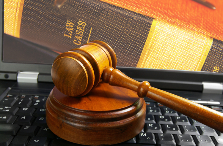 gavel on keyboard with book in background