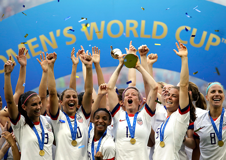US Women's soccer team lifting the World Cup trophy