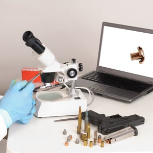 bullets being examined with microscope