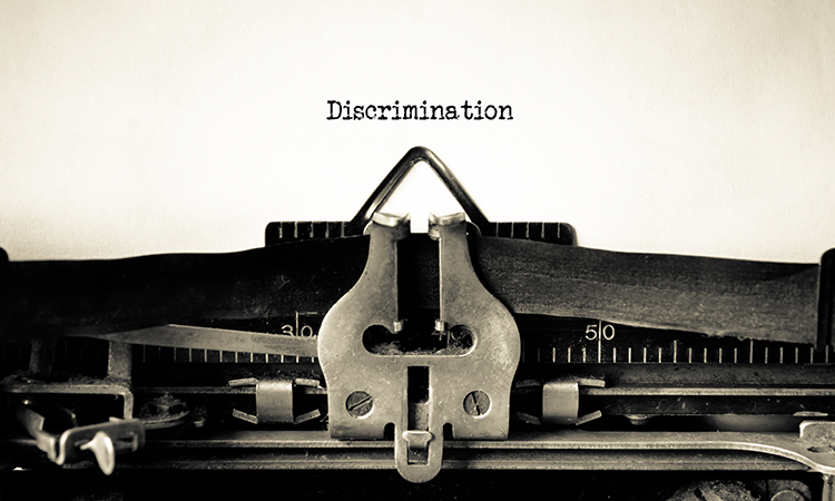 typewriter with the word discrimination typed out