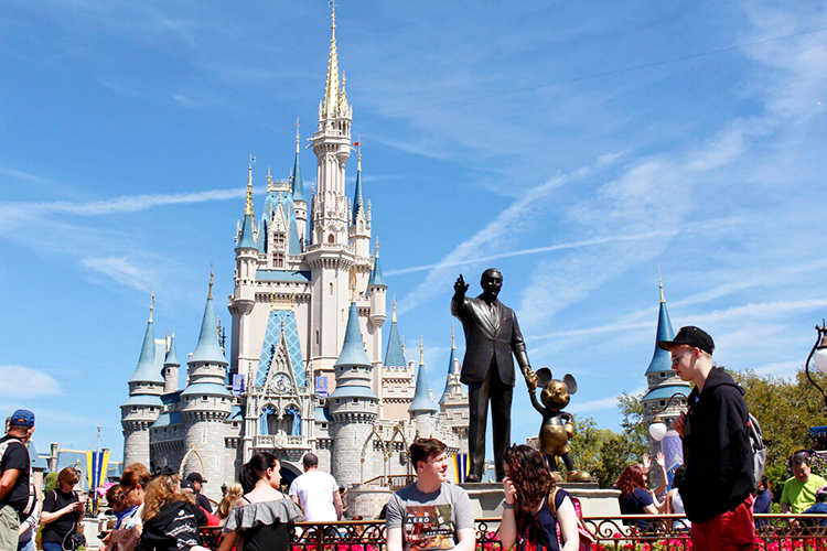 People mill around in Disney World in Orlando
