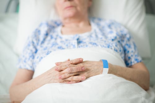 elder woman in nursing home bed