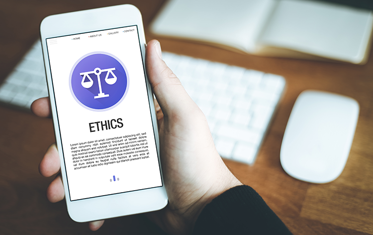 Hand holding a smartphone with an ethics app.