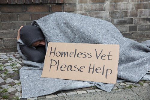 homeless veteran with sign