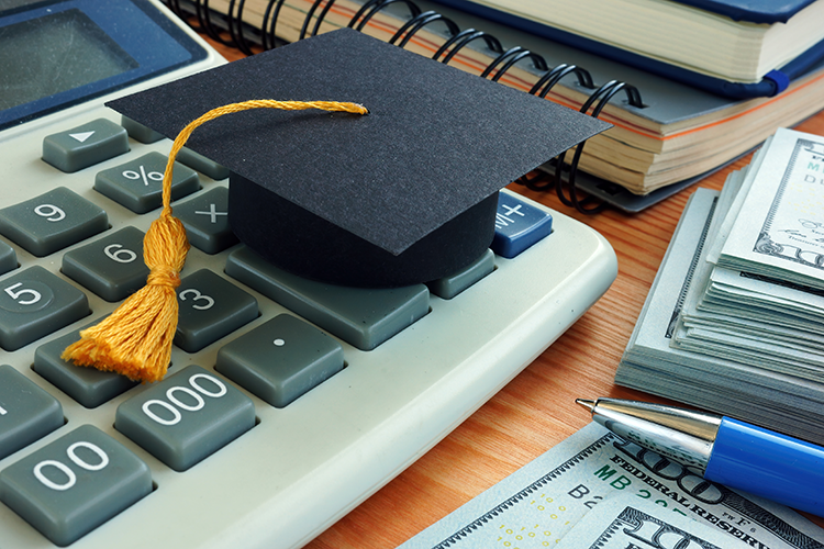 grad cap and calculator and cash