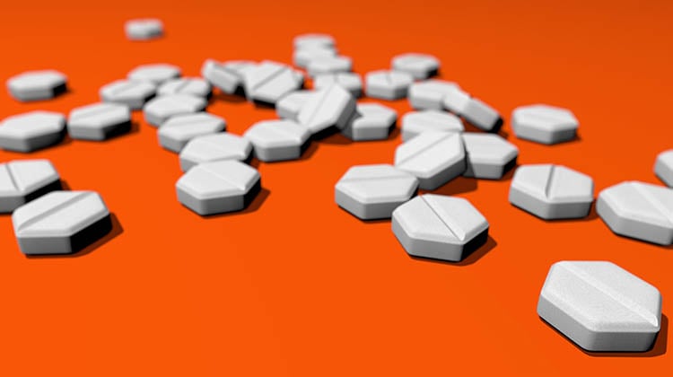 Hexagonal pills on orange background.