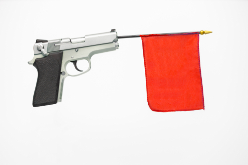 gun with red flag