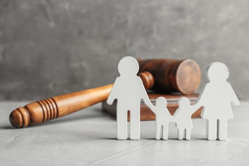 shutterstock_family figure and gavel on table