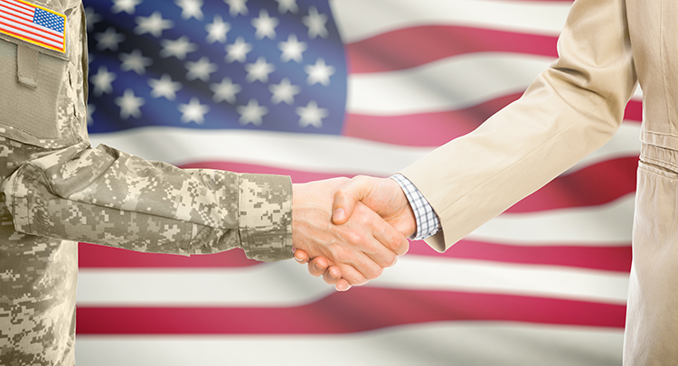 Soldier and lawyer shaking hands in front of an American flag
