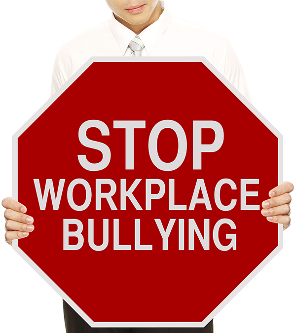 Man holding a sign that says stop workplace bullying