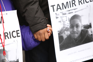 Children hold hands at a protest over the death of Tamir Rice