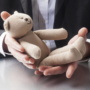 Businessman holding teddy bear